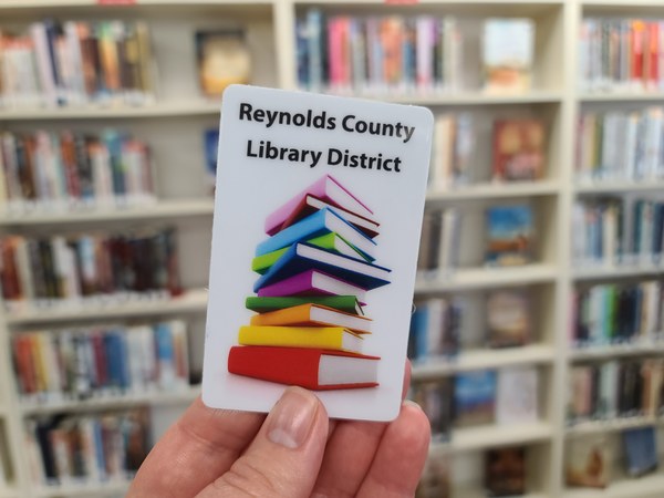 Image of a hand holding a Reynolds County Library District library card